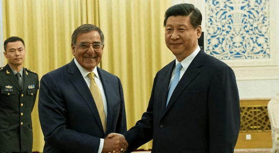 Two men in suits shaking hands in front of a room with cybersecurity concerns.