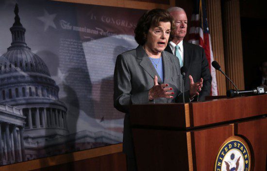 two people standing at a podium in front of a u.s. capitol building.