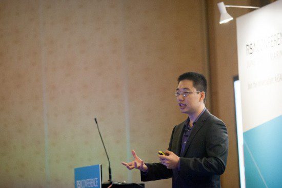 a man giving a presentation on mobile security at a conference.